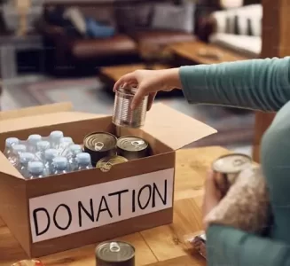 A woman leaving goods in a donation box